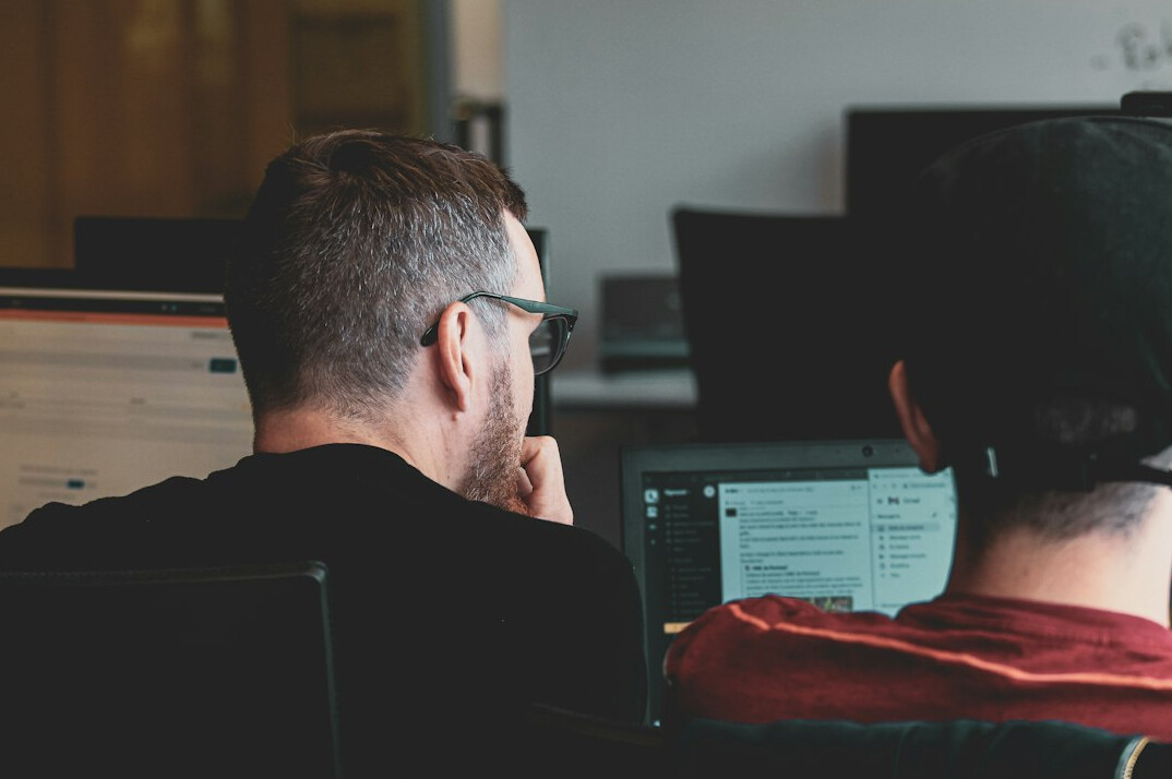 team of programmers working on code
